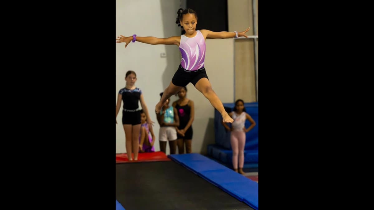 Gymnast practicing splits during training